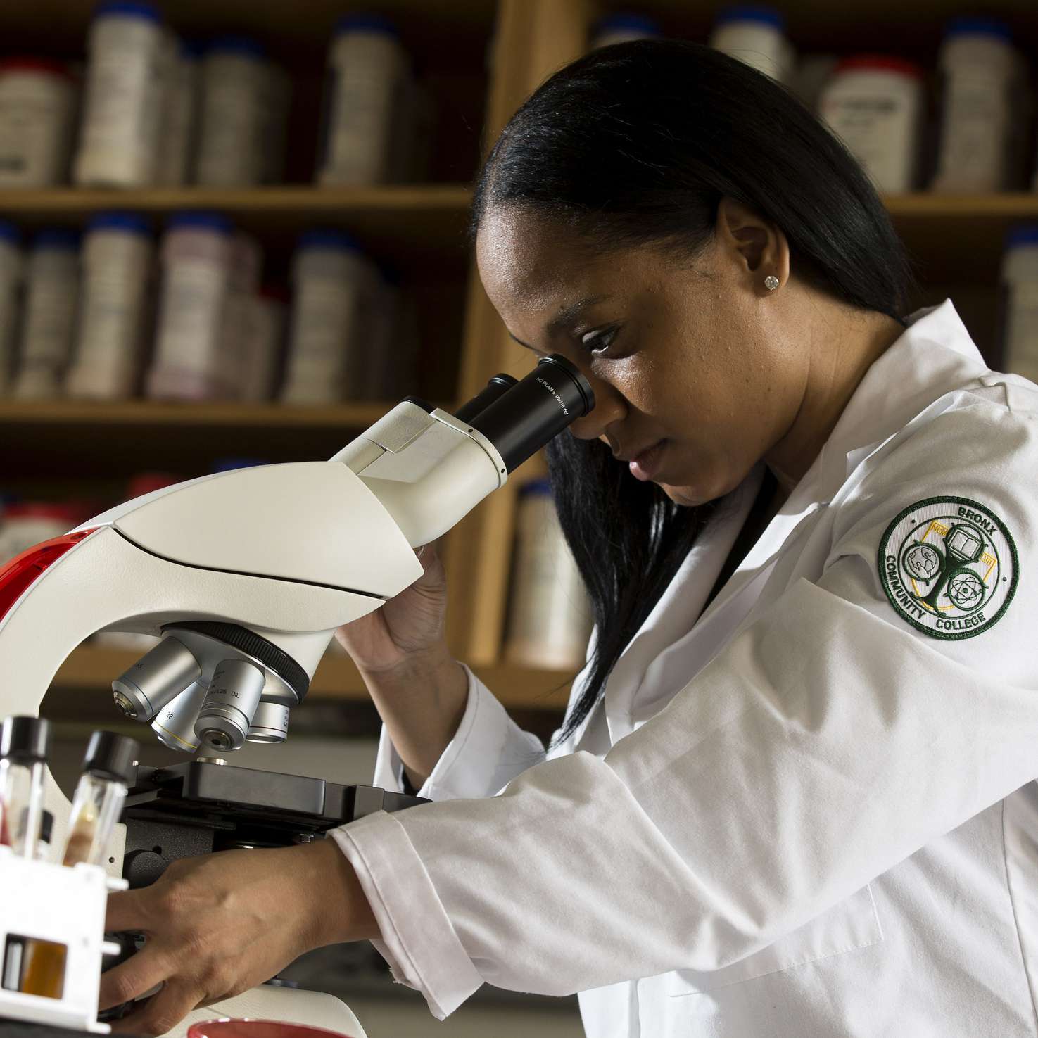 Girl looking through a microscope