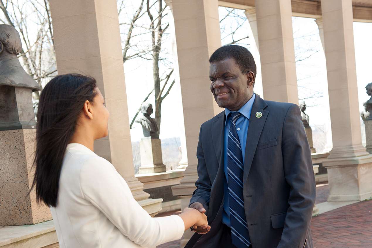 President Isekenegbe with student in the Hall of Fame Colonnade