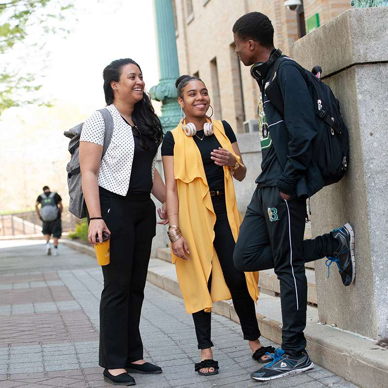 Students relaxing outside by Nichols hall