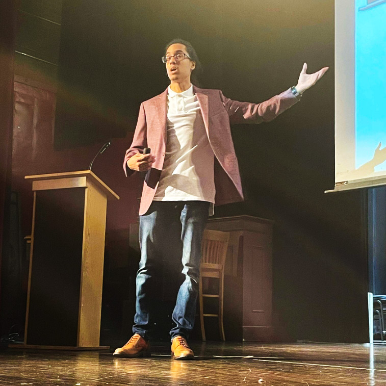 TechFest: Presenter on stage gesturing at screen